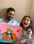 Father and daughter laughing holding a canvas of themselves